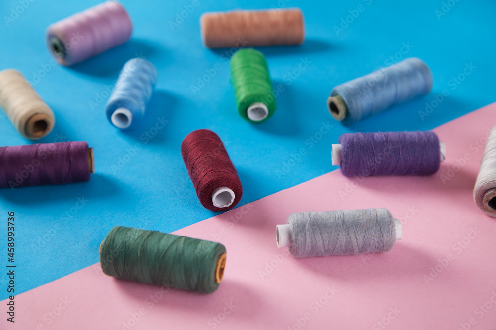 Colorful threads isolated on pink and blue backgrounds. Colorful threads isolated on pink and blue backgrounds.