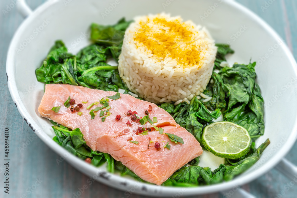 Salmon fillet with rice and spinach garnish.