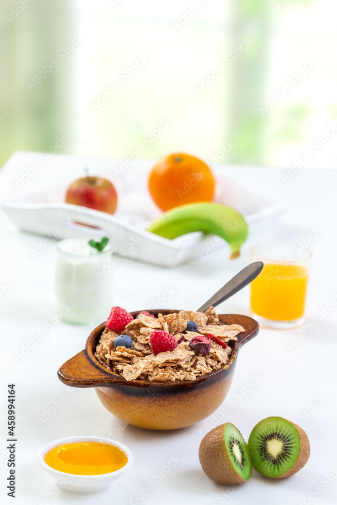 Healthy breakfast with bowl of cereal, orange juice, milk, and fruits. Healthy breakfast with bowl of cereal, orange juice, milk, and fruits.