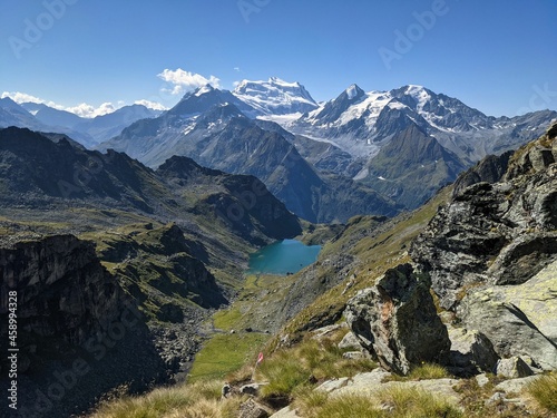 Lac de Louvie, mountain lake in valais and in the big mountains with glaciers. idyllic landscape with flowers. Alps