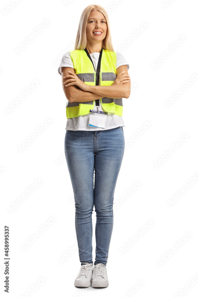 Full length portrait of a young female wearing a reflective vest and posing with crossed arms Full length portrait of a young female wearing a reflective vest and posing with crossed arms