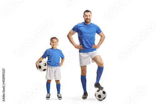 Man and boy with soccer balls wearing same color jersey © Ljupco Smokovski