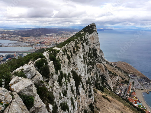 Aerial view of top of Gibraltar Rock, in Upper Rock Natural Reserve with Gibraltar town, Mediterranean Sea, cloudy day