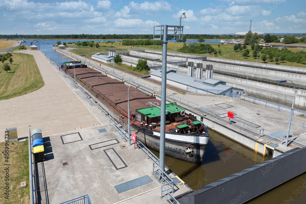 German sluice near Magdeburg with cargo ship in lock chamber