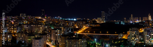 Beautiful panoramic cityscape of Cankaya, Oran and Dikmen districts in Ankara at night. Long exposure photography of Dikmen Valley Bridge and surrounding buildings.