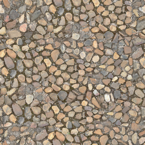 Stone pavement texture. Abstract background of cobblestone pavement close-up. Seamless texture. Perfect tiled on all sides.