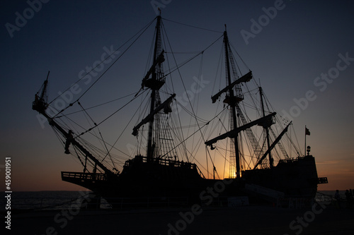 Fototapeta Naklejka Na Ścianę i Meble -  Pirate Sailing Ship Silhouette at Sunset.