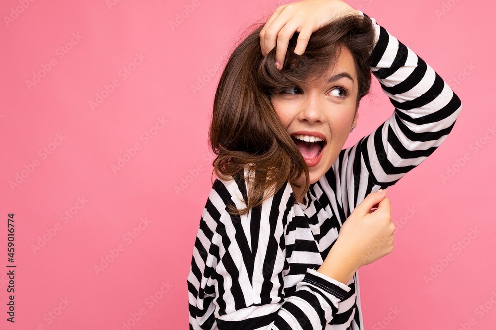 Photo shot of cute attractive pretty positive happy young brunette woman wearing casual striped longsleeve isolated over colorful background with copy space Photo shot of cute attractive pretty positive happy young brunette woman wearing casual striped longsleeve isolated over colorful background with copy space