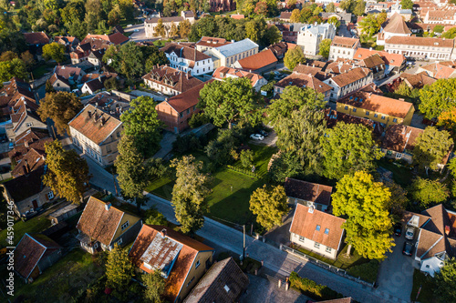 Aerial view of old town in city Kuldiga and red roof tiles, Latvia. Sunny autumn morning.