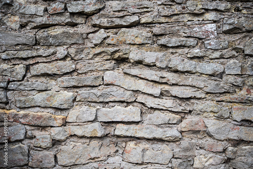 Wall, made of stones in Kuldiga, Latvia.