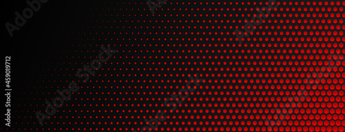 Abstract halftone background made of small hexagonal dots of different sizes in red and black colors