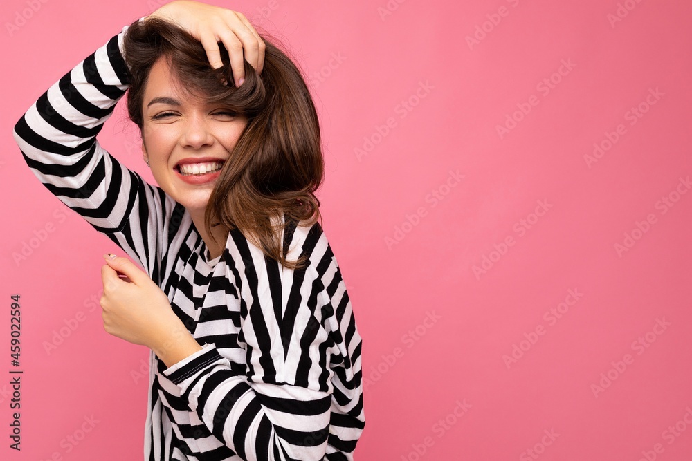 Fototapeta premium Portrait of positive cheerful fashionable woman in casual clothes isolated on pink background with copy space