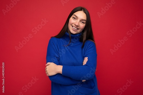 Photo shot of pretty joyful smiling young female person wearing casual trendy outfit standing isolated on colourful background with copy space looking at camera and having fun © Ivan Traimak