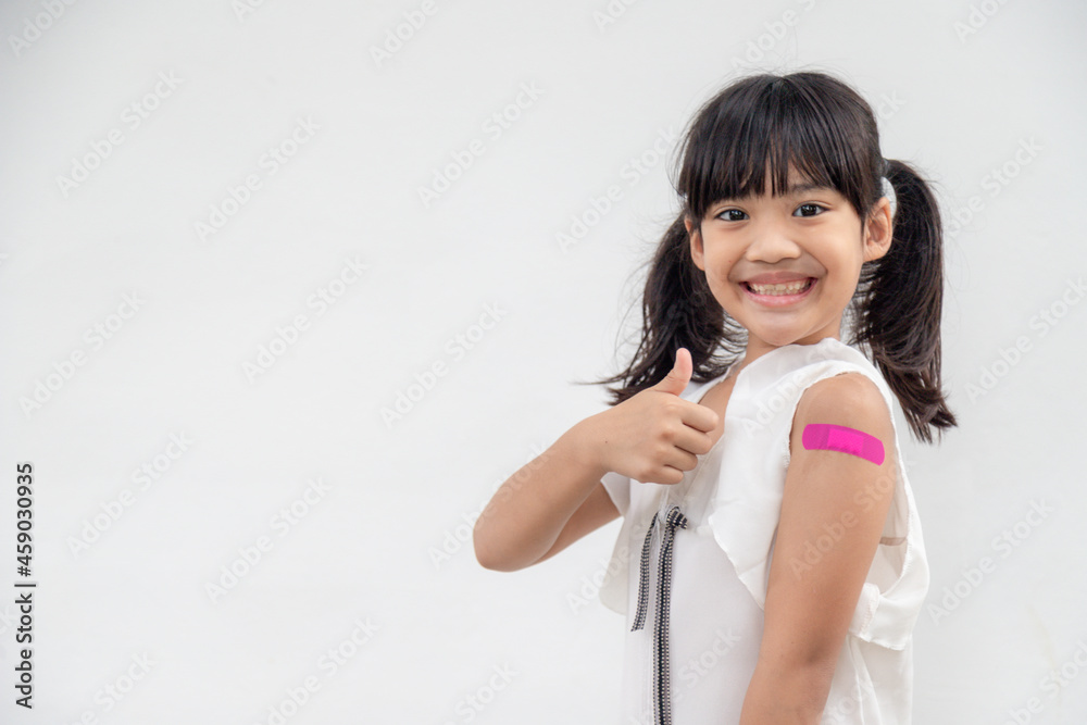Asian little girl showing his arm after got vaccinated or inoculation, child immunization, covid delta vaccine concept Asian little girl showing his arm after got vaccinated or inoculation, child immunization, covid delta vaccine concept