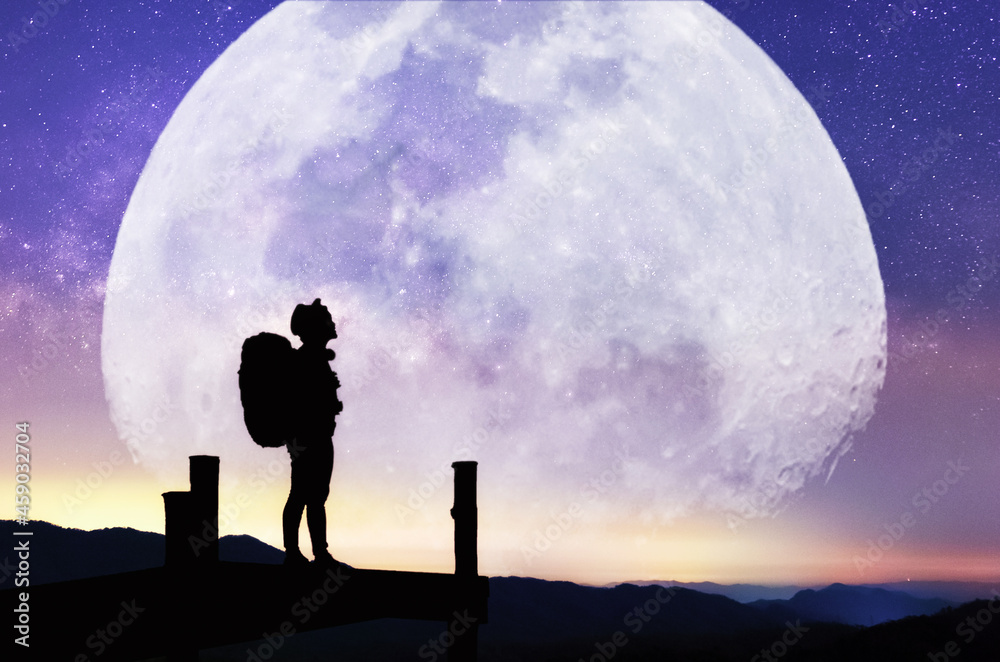 Landscape with Moon and Milky Way. Night sky with stars and silhouette of a standing happy women on the mountain, Success or winner, leader concept. High iso with Noise.