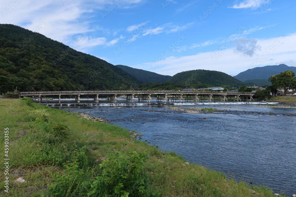 Obraz premium A tourist spot in Kyoto in Japan 日本の京都の観光地 : Katsura-gawa River and Togetsu-kyo Bridge at Arashiyama 嵐山にある渡月橋と桂川