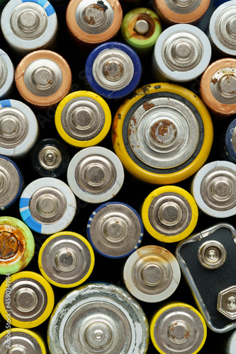 Close up top view of used battery. lot of AA batteries. Electronic hazardous waste, recycling concept 