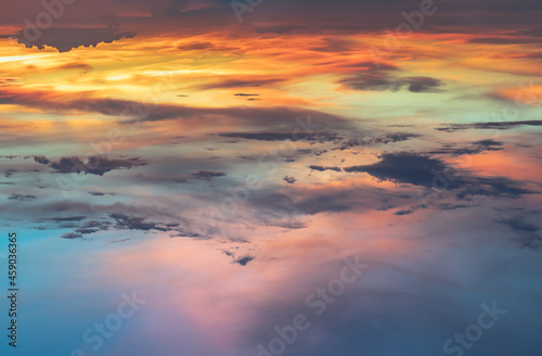 Beautiful sunset sky above clouds with dramatic light, Beautiful blazing sunset landscape, Copy space, Selective focus. © num