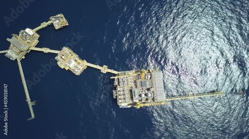 Drone shot of central processing platform (cpp) in the middle of the ocean on sunny day - upstream industry
 photo