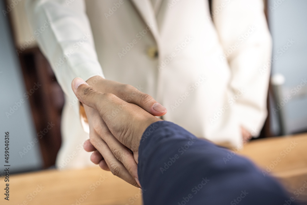 two businessman shake hand after complete success project with teamwork. close up of business man in suit handshake after finishing up a business meeting in the city, congratulation, success, meeting