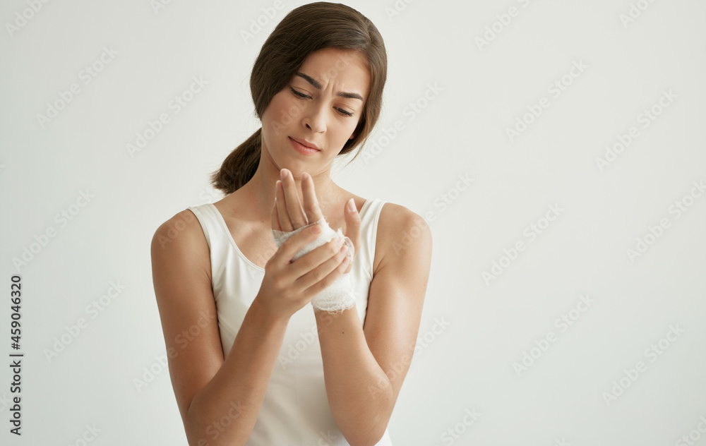 woman with bandaged arm injury health problems light background woman with bandaged arm injury health problems light background