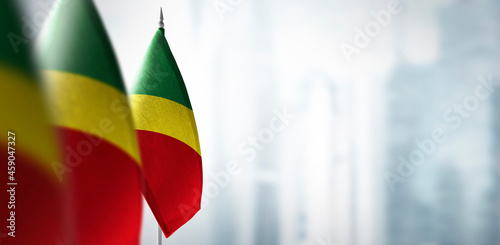 Small flags of Congo on a blurry background of the city