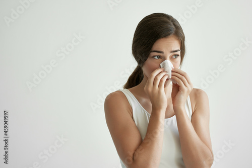 woman blowing her nose in a handkerchief flu virus health problems
