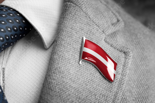 Metal badge with the flag of Latvia on a suit lapel