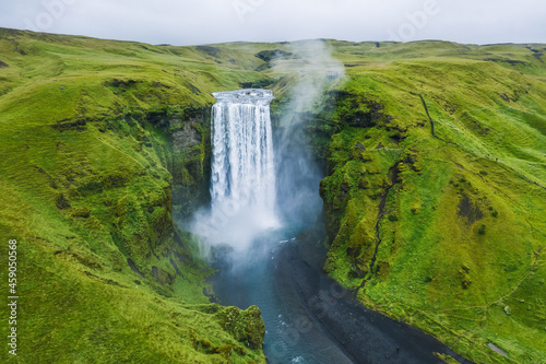 Fototapeta Naklejka Na Ścianę i Meble -  Aerial drone view of Skogafoss waterfall in Iceland, one of the most famous tourist visited attraction and landmark