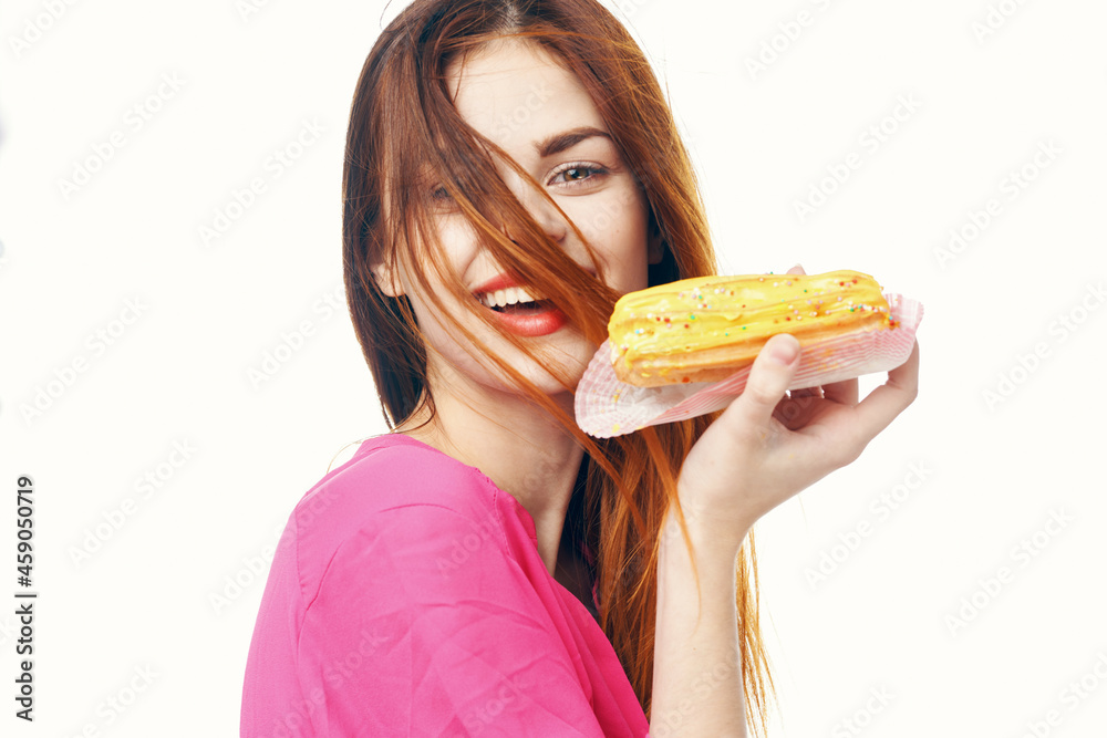 woman eating eclair Glamor snack close-up light background woman eating eclair Glamor snack close-up light background