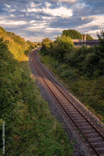 Small rail road at dusk, Cloudy sky. Nobody. Transportation industry