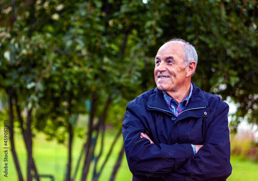 portrait of a senior person standing in the garden portrait of a senior person standing in the garden