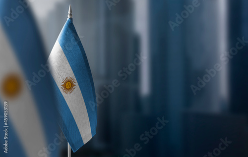 Small flags of Argentina on a blurry background of the city