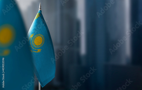 Small flags of Kazakhstan on a blurry background of the city