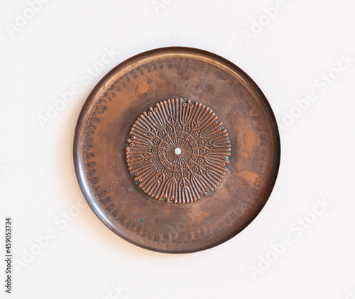 Mid-century modern copper wall plate - isolated on white wall