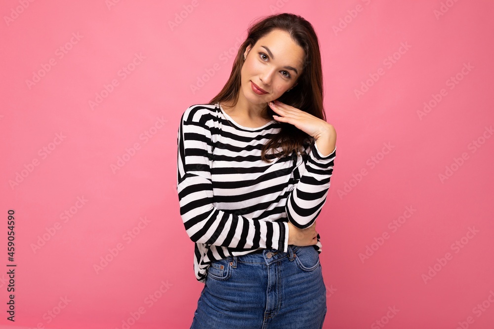 Photo shot of cute attractive pretty young brunette woman wearing casual striped longsleeve isolated over colorful background with copy space