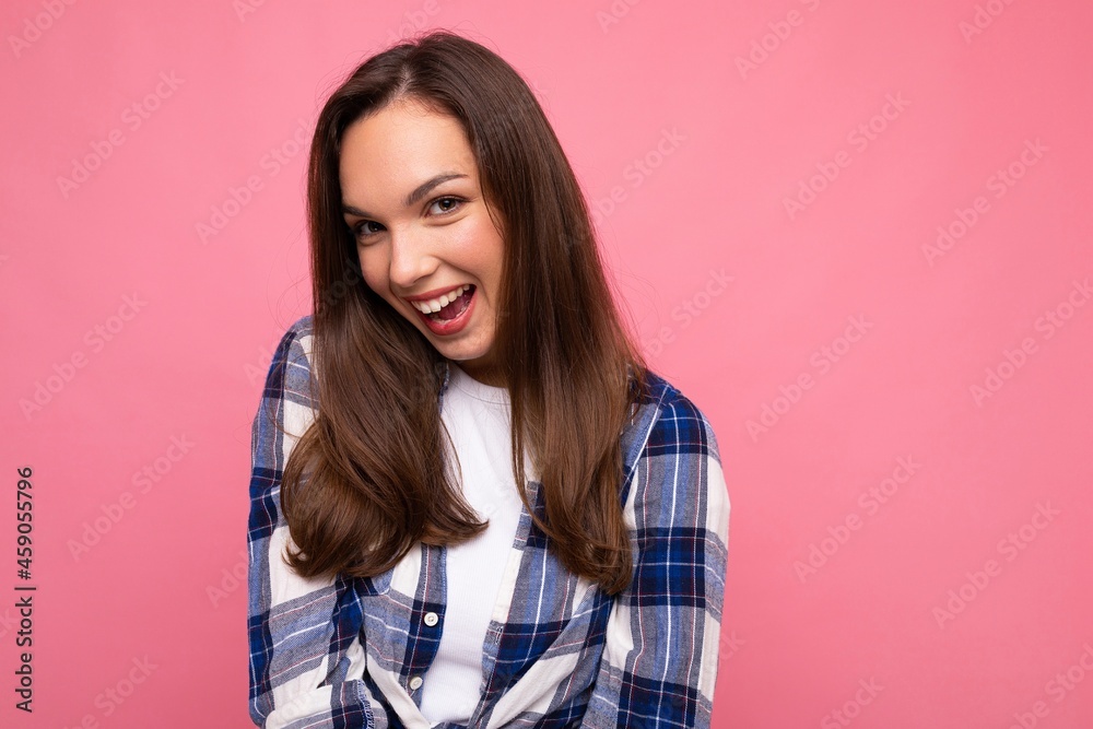 Photo portrait of young beautiful smiling hipster brunette woman in trendy blue and white shirt and jeans clothes. Sexy carefree female person posing isolated near pink wall with empty space in studio Photo portrait of young beautiful smiling hipster brunette woman in trendy blue and white shirt and jeans clothes. Sexy carefree female person posing isolated near pink wall with empty space in studio