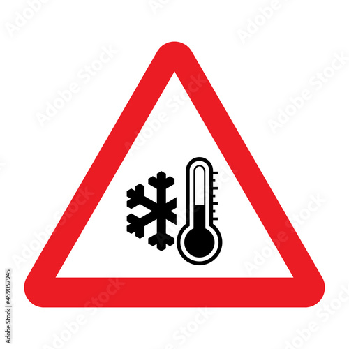 Low temperature warning sign. Vector illustration of red triangle sign with snowflake and thermometer icon inside. Caution symbol isolated on background. Winter concept. Very cold and freezing. 