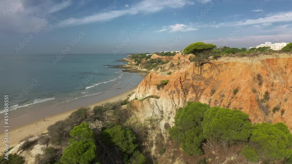 Albufeira, Portugal. Aerial view of the long stretch of sand of the beach, with a view of the Atlantic Ocean. Charming, isolated bay surrounded with rocky sea cliffs. High quality 4k footage Albufeira, Portugal. Aerial view of the long stretch of sand of the beach, with a view of the Atlantic Ocean. Charming, isolated bay surrounded with rocky sea cliffs. High quality 4k footage