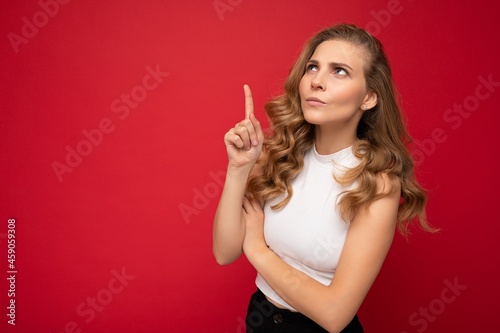 Photo of cute nice winsome angry dissatisfied adult woman wearing casual outfit isolated on background wall with copy space pointing at free space with hands