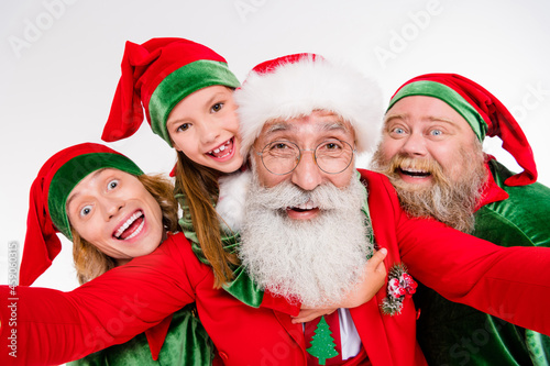 Self-portrait of attractive cheerful four people gathering December winter time having fun isolated over white color background