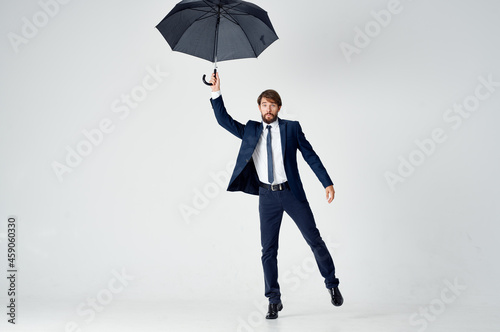 business man with umbrella in hands protection from rain bad weather Studio © SHOTPRIME STUDIO
