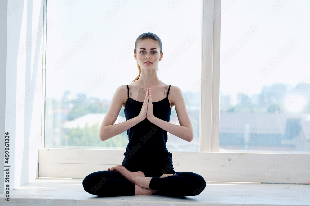 woman sitting in lotus position meditation rest near window woman sitting in lotus position meditation rest near window
