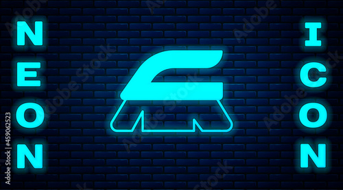 Glowing neon Brush for cleaning icon isolated on brick wall background. Cleaning service concept. Vector