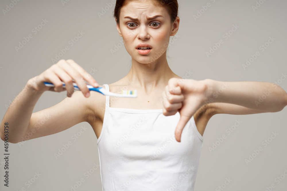 woman in white t-shirt dental hygiene health care light background woman in white t-shirt dental hygiene health care light background