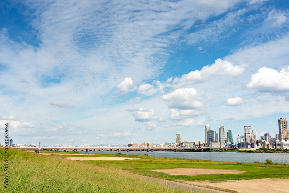 View of office buildings of central Osaka city from Yodogawa river bank