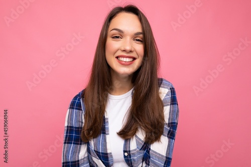 Portrait of positive cheerful fashionable woman in hipster outfit isolated on pink background with copy space © Ivan Traimak