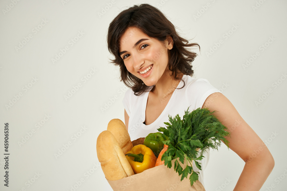 cheerful brunette with a package of groceries healthy food delivery cheerful brunette with a package of groceries healthy food delivery