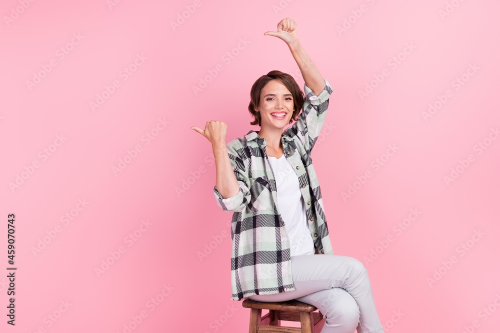 Photo of sweet millennial brunette lady point empty space wear shirt trousers isolated on pink background Photo of sweet millennial brunette lady point empty space wear shirt trousers isolated on pink background