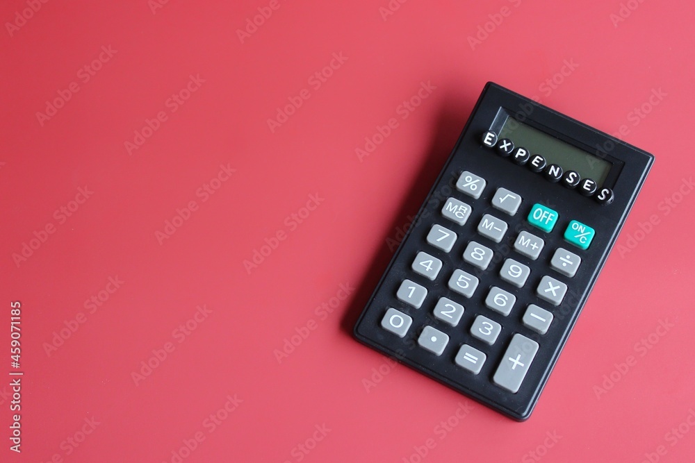 Business and finance concept. Calculator and alphabet beads with text EXPENSES. Business and finance concept. Calculator and alphabet beads with text EXPENSES.